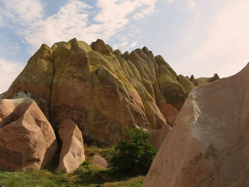Rock formations at cappadocia against cloudy sky