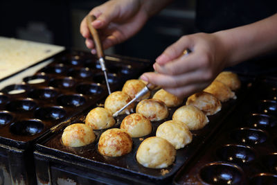 Close-up of person preparing food in kitchen