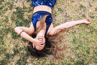 High angle view of woman lying down on field