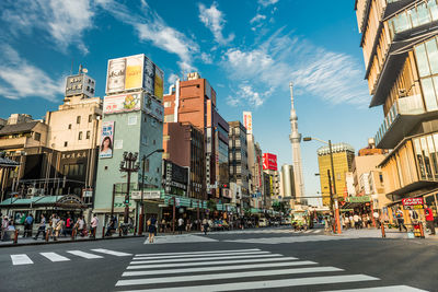 View of city street and buildings against sky