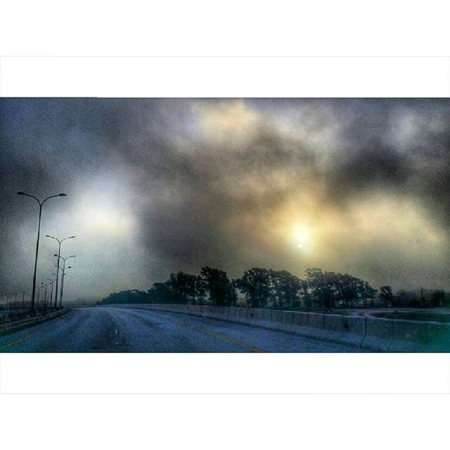 transfer print, sky, road, sun, auto post production filter, the way forward, tranquility, tranquil scene, cloud - sky, transportation, landscape, nature, field, scenics, diminishing perspective, sunbeam, beauty in nature, sunlight, cloudy, weather