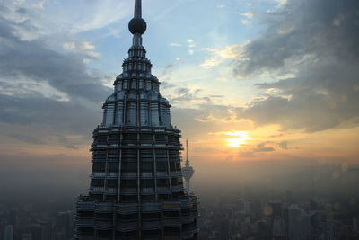 View of cityscape against cloudy sky