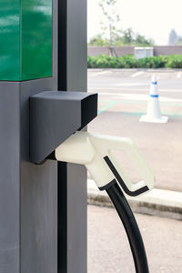 Power supply connecter to plug-in electric vehicle or electric car at charging station in car park