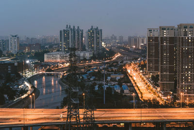 High angle view of illuminated city buildings at night