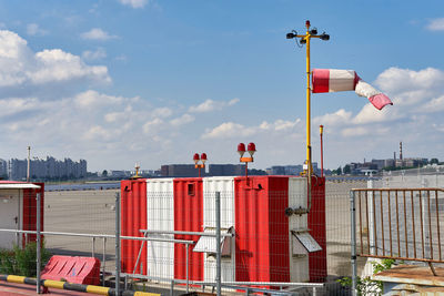 Red flag by building against sky