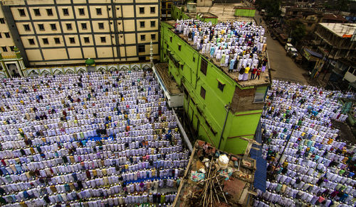 High angle view of people praying at mosque 