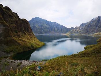 Scenic view of lake and mountains against sky