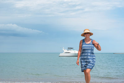 Full length of man standing by sea against sky