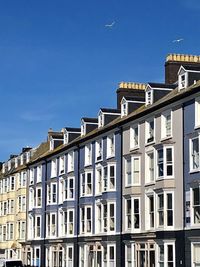 Low angle view of buildings against blue sky