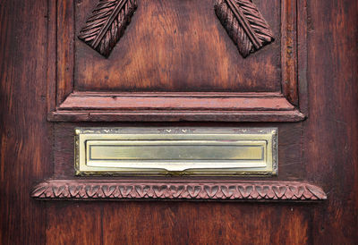 Close-up of mailbox on door