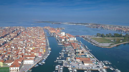 High angle view of buildings by sea against sky