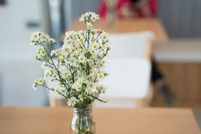 White flower vase on table