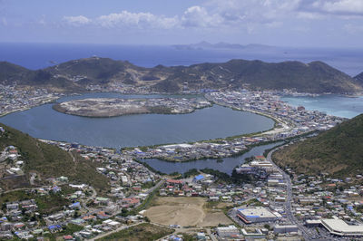 High angle view of bay and cityscape against sky