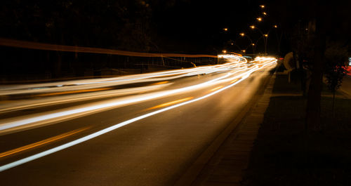 High angle view of light trails on road at night