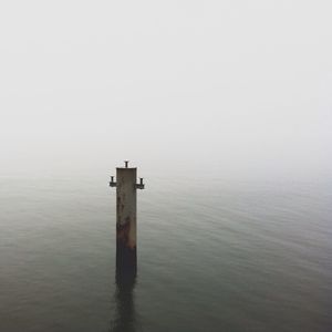 View of wooden posts in sea