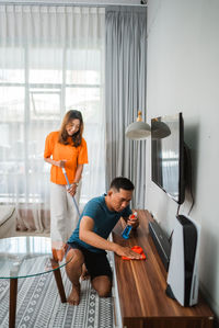 Side view of young woman working at home