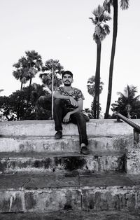 Portrait of young man sitting on steps