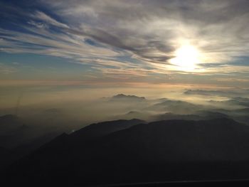 Scenic view of mountains against cloudy sky