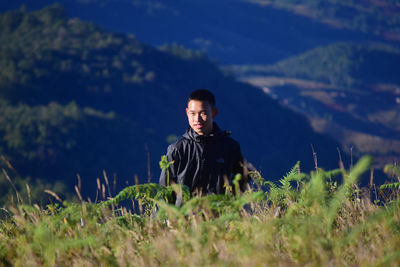 Young man sitting on field