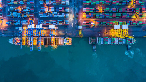 High angle view of illuminated container ship at commercial dock