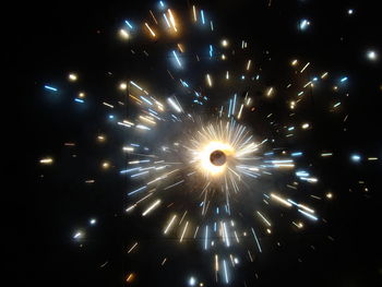 Low angle view of firework display at night