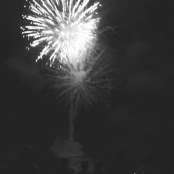 Low angle view of firework display at night