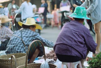 Rear view of vendors selling food at market