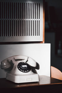 Close-up of old telephone on table at home