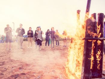 Panoramic shot of people on shore against clear sky