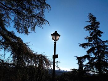 Low angle view of street light against blue sky