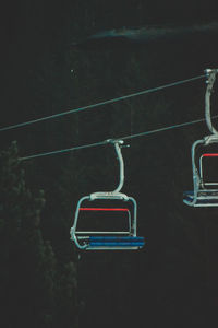 Directly above shot of ski lift against tree at night