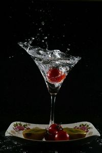 Close-up of drink on table against black background