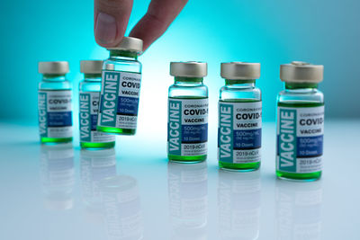 Midsection of person with bottle in container