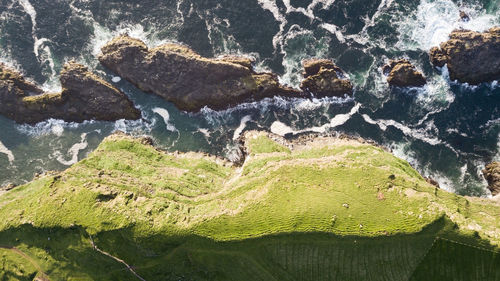 High angle view of rocks by sea