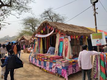 Rear view of people at market stall