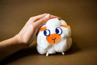 Close-up of hand holding stuffed toy