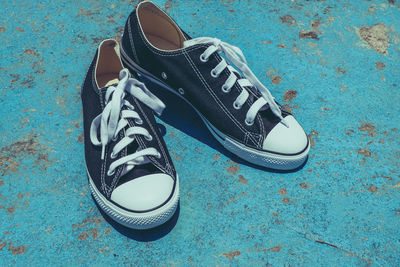 Close-up of shoes on blue floor