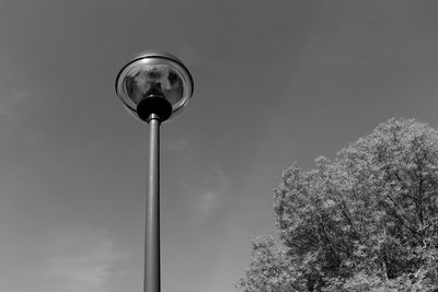 Low angle view of street light against blue sky