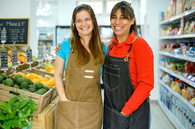 Portrait of smiling young woman standing at market