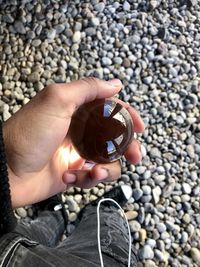 High angle view of person hand holding stones