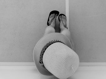 Directly above shot of girl wearing sun hat by wall