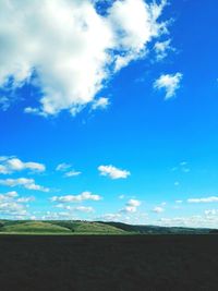 Scenic view of landscape against blue sky