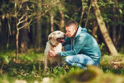 Man with dog sitting on grass