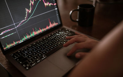 Young woman looking at the market on laptop