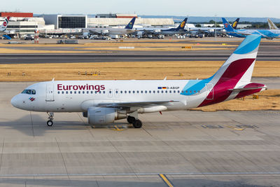 High angle view of airplane on airport runway against sky