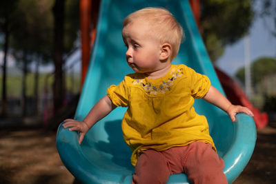 Boy playing with slide at playground