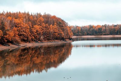 Reflection of trees in lake against sky during autumn