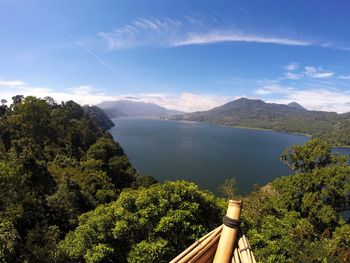 Scenic view of sea and mountains against sky