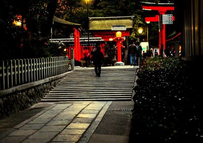 People walking on steps at night