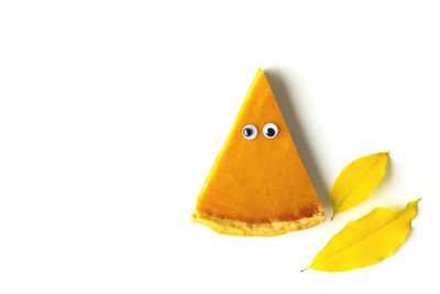 Close-up of yellow fruit against white background